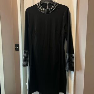 VENUS black dress w/ rows of round silver hardware detail around neck and cuffs.